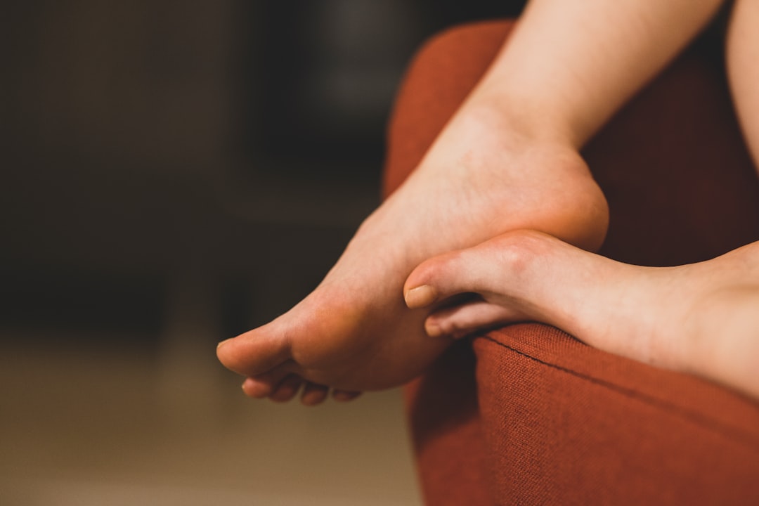 persons feet on brown textile