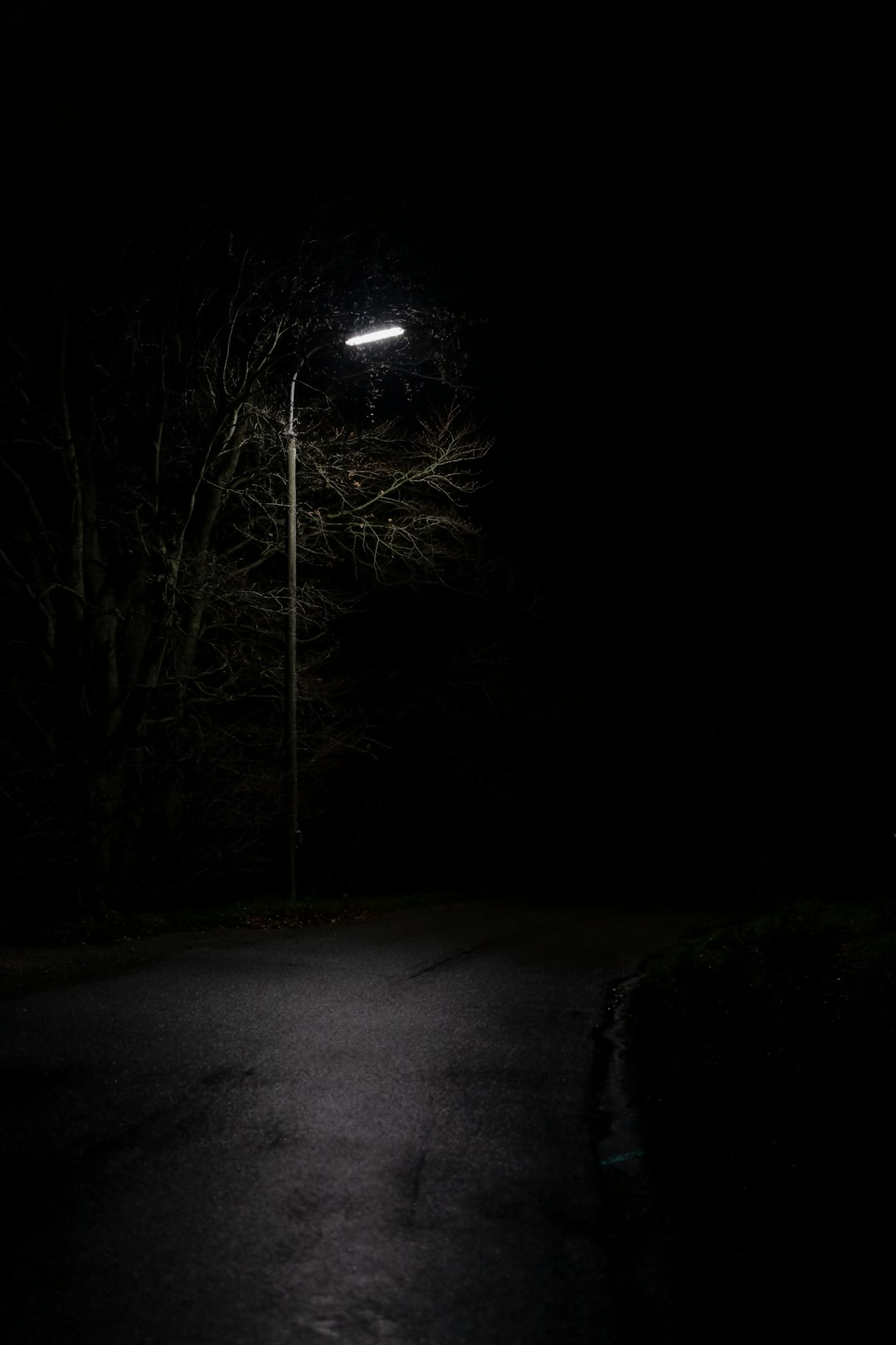 view of empty road under light post